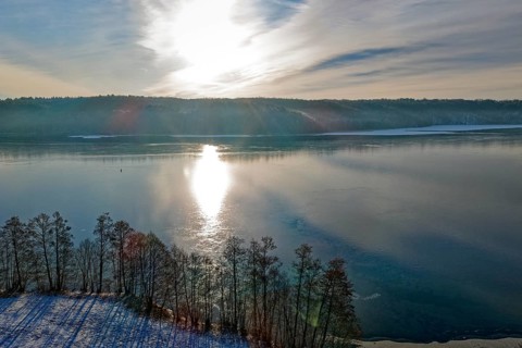 The sun reflects on Lake Werbellin in the UNESCO Schorfheide-Chorin Biosphere Reserve in winter.