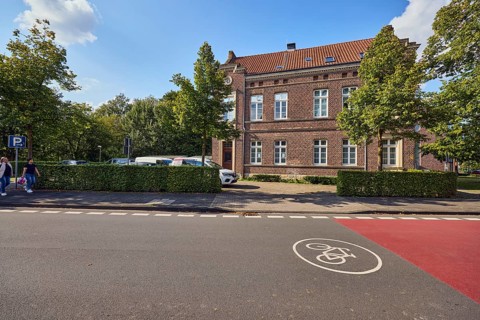 Bicycle road, brick houses, commercial buildings, job center, registry office, parking lot with
