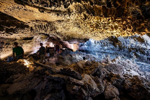 Underground cave formed by lava flow, visitors in illuminated lava cave, Cueva de los Verdes,