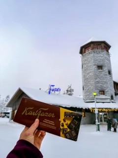 Karl Fazer hand holding chocolate in front of a Fazer shop, typical Finnish chocolate, Ranua,