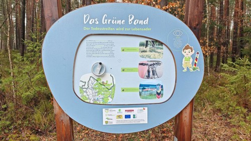 Information sign about the Green Belt in a wooded area, hiking on the former inner-German border on
