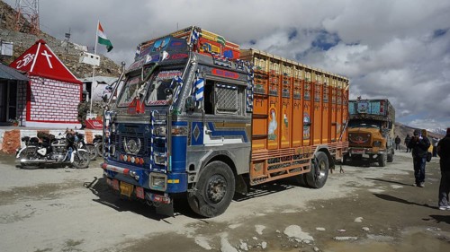 Colourful Indian truck parked at Khardung-La Pass, trekking in Ladakh, Stok la, Himalayas, India