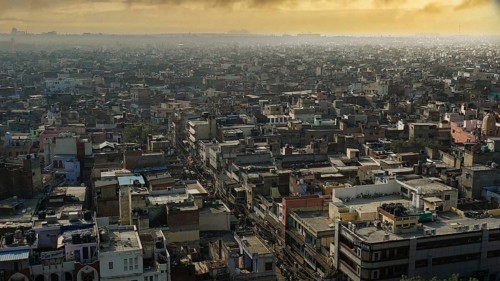 View of the rooftops of an expansive cityscape at sunset, Delhi, India