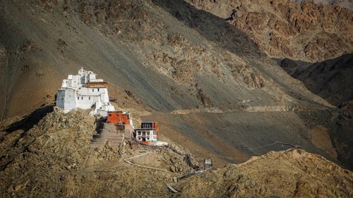 Namgyal Tsemo Buddhist monastery nestled in the barren mountains on a escarpment, Leh, trekking in
