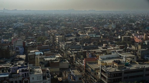 Wide view of the rooftops of Delhi's vast cityscape under a milky sky, Delhi, India