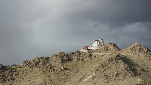 Namgyal Tsemo Buddhist monastery in Leh perched on a rocky hill under impending clouds, mountain