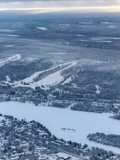 View of the snowy town of Rovaniemi with the Kemijoki river, in winter, aerial view, Finland