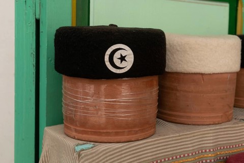 A black with crescent and star motif Tunisian Chechia, traditional soft wool hats popular in the