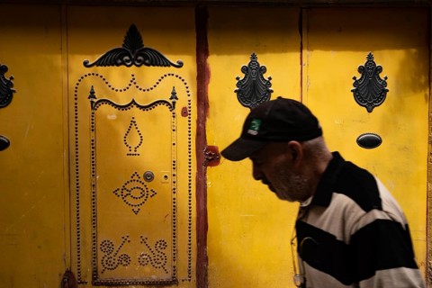 Tunis, Tunisia 7th May, 2024 Beautiful decorated traditional yellow door in the souk of Tunis