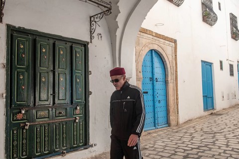 Tunis, Tunisia 4th May, 2024 A Tunisian man wearing a red chechia hat in the beautiful narrow
