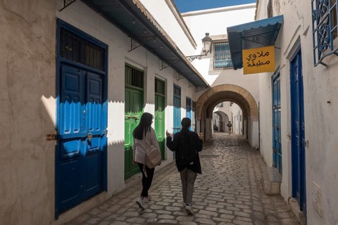 Tunis, Tunisia 4th May, 2024 Two young Tunisian women walk in the traditionally decorated narrow