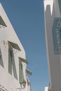 Mediterranean style architecture of shuttered windows and white washed walls in the Medina of
