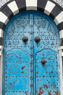 Detailed design of a traditional blue door in the Tunisian cliff top village of Sidi Bou Said,