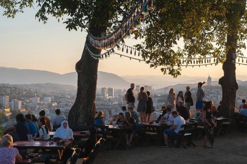 Sarajevo, Bosnia. July 25th 2019 Tourists watch the sunset from the terrace of the Park Princeva