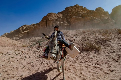 Petra, Jordan. December 12th 2012 A Jordanian Bedouin boy riding a donkey, Petra, Jordan