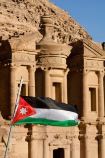 Petra, Jordan. December 11th 2012 The Jordanian flag fluttering in front of The Monastery, El Deir,