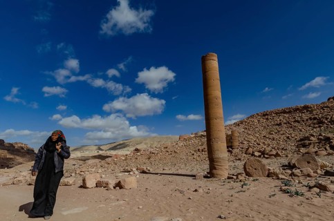 Petra, Jordan. December 11th 2012 A Jordanian Bedouin woman near a monument known as the Pharaohs