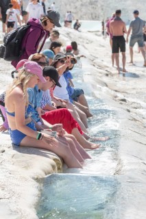 Pamakkule, Turkey, April 25th 2020 Tourists soak their feet in the thermal waters of the Travertine