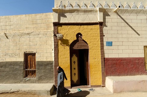 Aswan Egypt. January 10th 2013 Nubian Muslim man leaving a brightly coloured Mosque on Elephantine