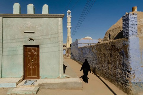 Aswan, Egypt. 11th January 2013 A Muslim woman walking towards a mosque in a Nubian Village on the