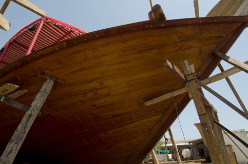 Sur, Oman. May 27th 2014 The wooden hull of a traditional Omani Dhow under construction in a ship