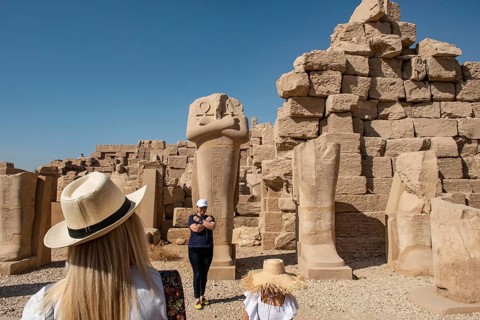 Luxor, Egypt. December 12th 2022 Tourists posing for selfie photographs beside Egyptian statues at