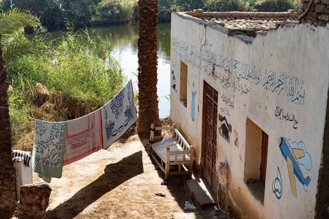 Luxor, Egypt. 13th December 2020 Typical Nile side house with painted Haj pilgrimage murals in a