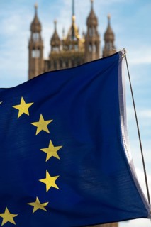 European flag with the British Houses of Parliament, the seat of the UK government in Westminster,