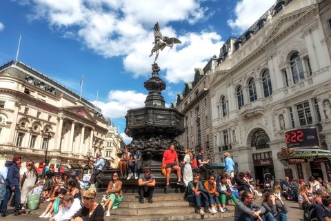 London, United Kingdom, June 28th 2022 Tourists sitting on the steps of the Shaftesbury Memorial