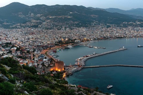 Beautiful evening view of Alanya Harbour and the Red Tower with the Taurus Mountains and