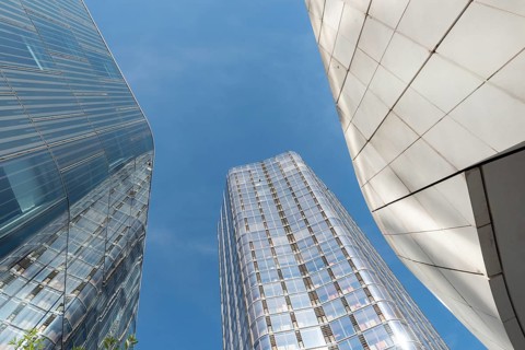Conceptual futuristic modern glass fronted high rise office buildings in the financial and banking