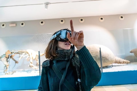 Woman wearing a vr headset interacting with virtual elements and exploring an augmented reality