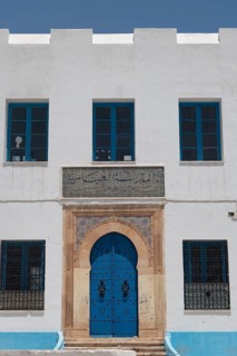 The beautiful blue ornate door and architecture of the Abbasid School inside the Medina of Sfax,
