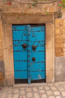 A blue wooden door, traditional local architecture in the Medina of Tunis, a UNESCO designated