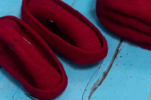 A Tunisian artisan puts the finishing touches to a red Chechia in Souk Ech-Chaouachine, part of the