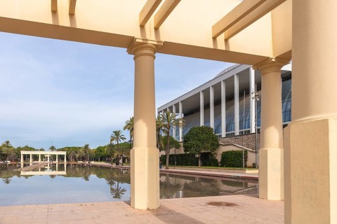 Palau de la musica building's modern architecture contrasts with classical columns of a pergola