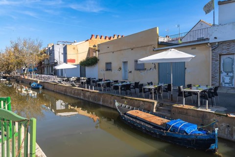 El palmar fishing village showcasing a narrow canal with traditional boats, a row of charming