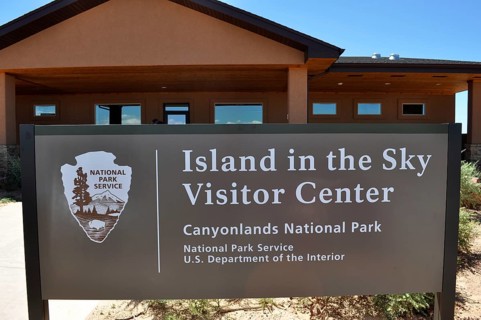 Island in the Sky Visitor Center sign in Canyonlands National Park in front of the center,