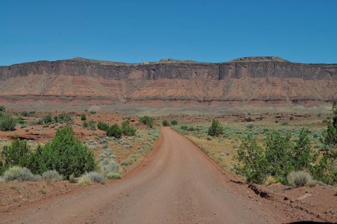 Straight gravel road through a flat, wide desert landscape, Canyonlands National Park, Island in
