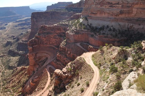 Narrow gravel road winds along steep rocks in a canyon landscape, Canyonlands National Park, Island