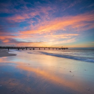 Pier on the fine sandy beach of the Baltic Sea at sunset, Baltic resort Rerik, Mecklenburg-Western