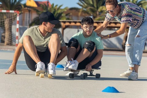 A teenager with Down syndrome enjoys sports with his family, promoting inclusion and joy They
