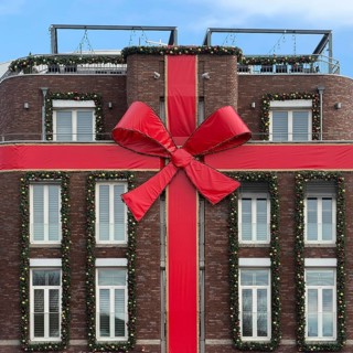 Large red ribbon on a house façade in the run-up to Christmas, Roermond, Limburg province, the