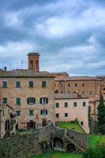 A charming view of Volterra, Tuscany, featuring traditional stone houses and rustic architecture.