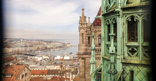 An atmospheric perspective from Geneva Cathedral's spire, showcasing a panoramic view of the city