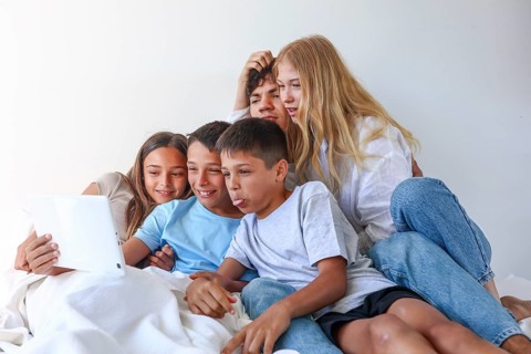 A heartwarming family portrait featuring an older brother and sister enjoying a fun moment with