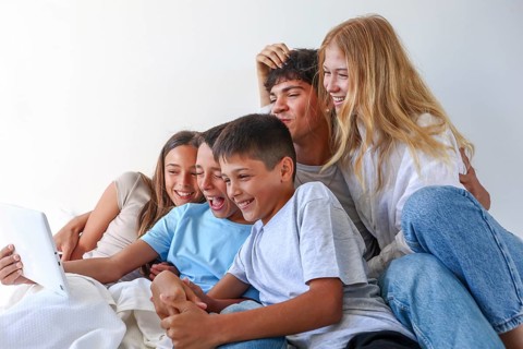 A joyful moment at home with five siblings, an older brother and sister with their younger triplet