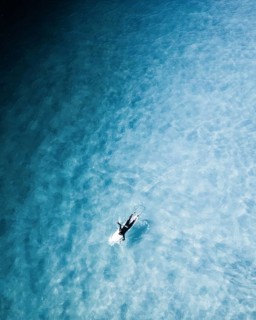 A captivating surf session in Portugal showcasing surfers navigating clear blue water. The image