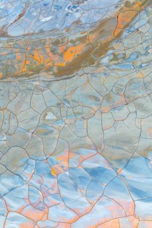 Multicolor cracked mud texture showcasing vibrant patterns and natural hues Abstract art created by