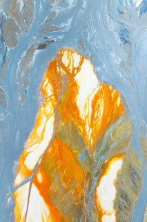 Vibrant multicolor abstract texture featuring dynamic orange and blue hues The flowing patterns